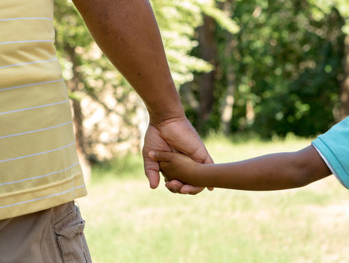 father and son holding hands