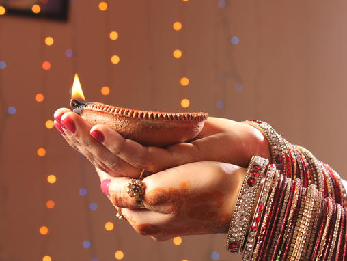 Lady holding candle for Diwali